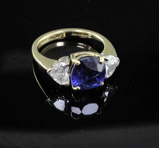 An 18ct gold, synthetic sapphire and heart shaped diamond ring, size M.